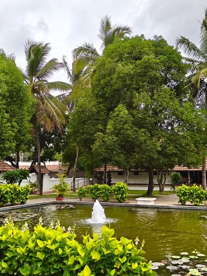 The central pond with its fountain, surrounded by lush greenery and our traditional cottages. This is the heart of our healing village.