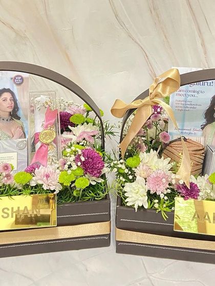 The 'Aabushan' branding is prominently displayed on these luxurious floral hampers, ensuring a strong brand presence for their corporate event.