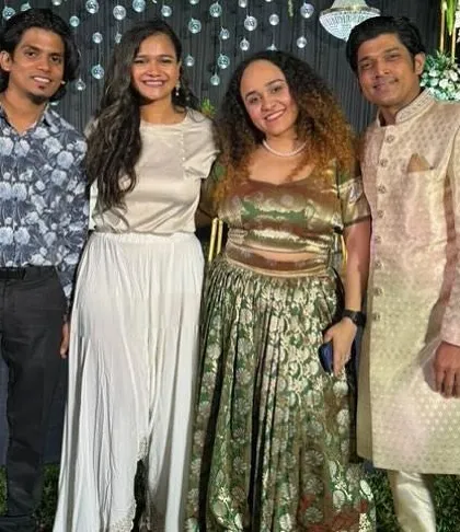 Posing with friends and guests at a beautiful outdoor wedding event.