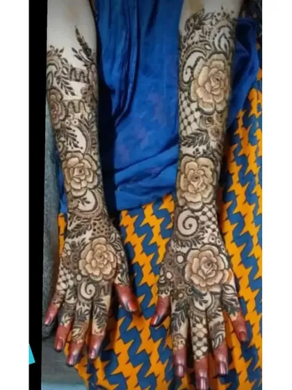 A full-arm bridal design with large, prominent rose patterns. This is a romantic and timeless choice for any bride.