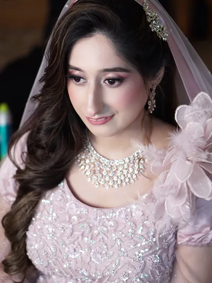 Aaliyah's engagement look is the definition of soft glam. The gentle pink hues and shimmering details create a look that is radiant, romantic, and utterly timeless.