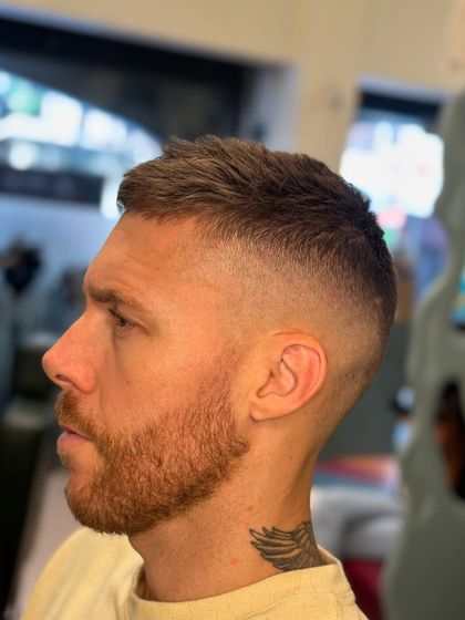 A high taper buzz cut. This style is extremely clean and sharp, perfect for a no-fuss, stylish look.