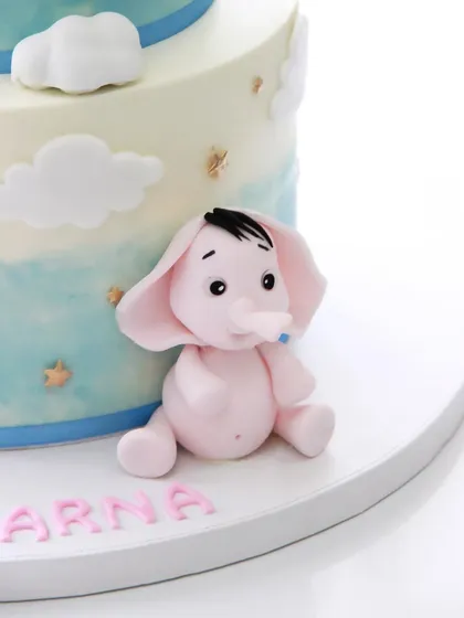 The adorable pink elephant topper, one of the three cute characters on this special cake.