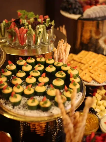 It's all about the details. This is a spread of my gourmet canapés, including cucumber cups with hummus and vegetable crudités in shot glasses. Each bite is designed to be a burst of flavour and a feast for the eyes.