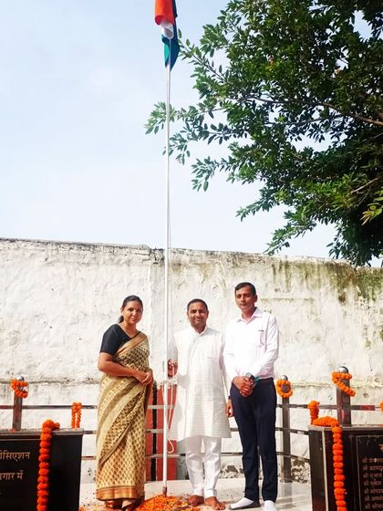 With colleagues at a flag-hoisting ceremony, a moment of national pride.