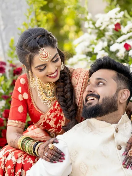 The joy on a bride's face is what makes my work so rewarding. Here you can see how the deep stain of the henna complements the bride's red saree and gold jewelry, completing her beautiful muhurtham look.