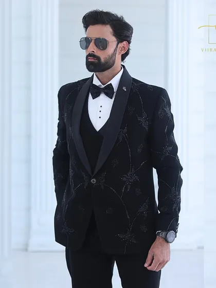 This black-on-black embroidered tuxedo is a favorite among grooms for its understated elegance. The floral pattern adds a modern twist to the classic black tuxedo.