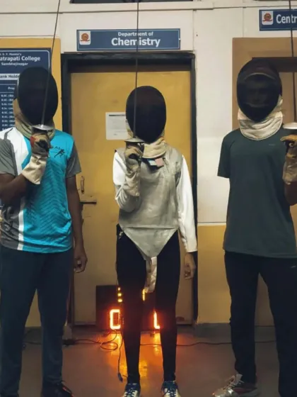 Three of our dedicated fencers pose in their gear. This photo captures the pride and readiness of our athletes after a challenging training session.