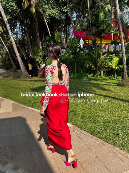 A point-of-view shot from a wedding stylist, capturing the bride's look in motion against a beautiful backdrop.