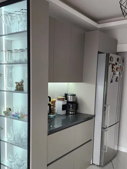 Another angle of the crockery and display unit, showcasing how the two pieces work together to create a complete and functional storage solution next to the refrigerator.