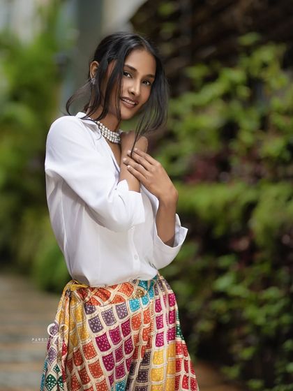 A sweet and gentle pose in a natural setting. The soft light and her serene expression create a portrait that is both beautiful and calming.