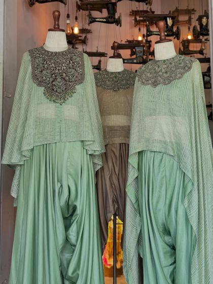 A trio of stunning Prisho silhouettes in our store window, their embellished capes and draped pants stealing the spotlight.