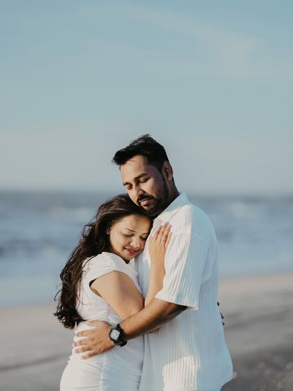 A heartfelt embrace by the ocean. This photo captures a feeling of comfort and security, showing a couple finding home in each other's arms.