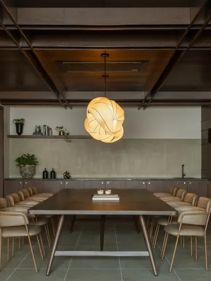 Within the larger auditorium project, we created this intimate VIP lounge design. It serves as a quiet, refined retreat for meetings or private conversations, featuring a custom conference table, sophisticated lighting, and rich wood textures for a cozy, exclusive feel.