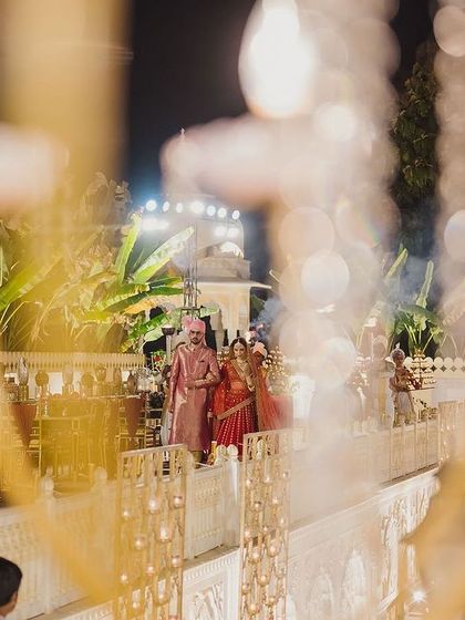The couple's entry along the palace corridors. The warm lighting and architectural details created a naturally royal and romantic pathway for their arrival.