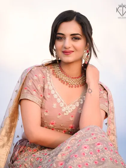 A seated portrait of the model from the "Rishte" song shoot, looking elegant and poised.