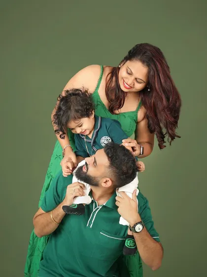 Chaos, love, and priceless memories. This playful family portrait, with their son on dad's shoulders, perfectly captures the fun and energy of family life.