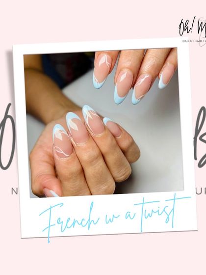 A French manicure with a modern twist. This design features soft baby blue tips with abstract white swirls, creating a dreamy, cloud-like effect.