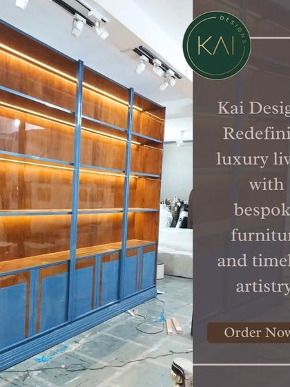 A large, custom-built display cabinet in a striking blue lacquer with a warm wood interior. The integrated backlighting turns stored items into a beautiful display, perfect for a library or living room.