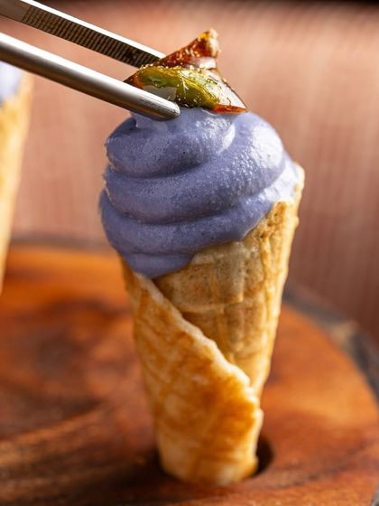 A playful black carrot soft serve in a mini cone, topped with chikki. This was a delightful and surprising dessert from our Christmas menu.