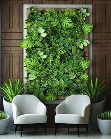 A framed artificial plant arrangement designed as a centerpiece for a waiting area. The use of large-leaf plants like Monstera gives this piece a bold, tropical feel.