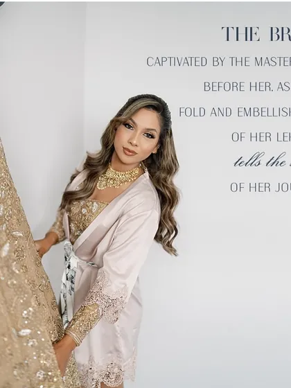 The bride, captivated by the masterpiece before her. This shot captures the moment she sees her custom golden lehenga, a culmination of her journey with us.