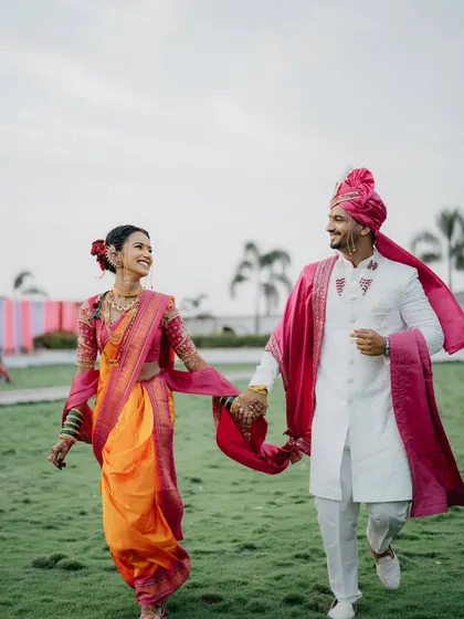 There's a special kind of magic in Marathi weddings. This candid shot of a couple, walking hand-in-hand in their traditional attire, is all about that feeling of 'pyar hua chupke se', a love that feels both grand and beautifully simple.
