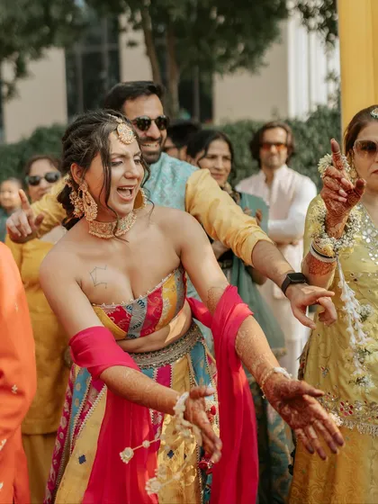 Pure celebration! The couple dances with abandon, surrounded by their loved ones.