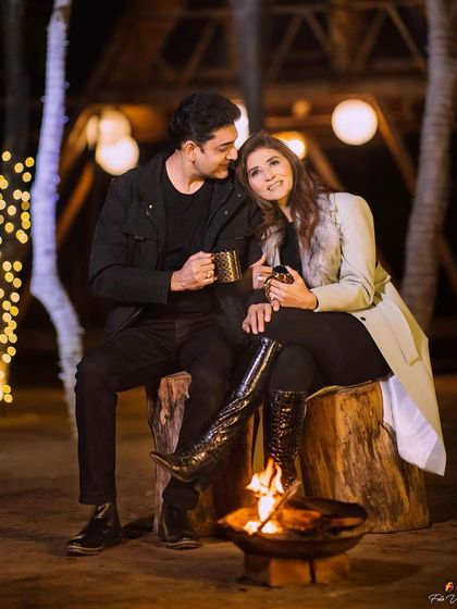 A cozy and romantic evening shot by the fire. The makeup is soft and warm, creating a beautiful glow in the firelight.