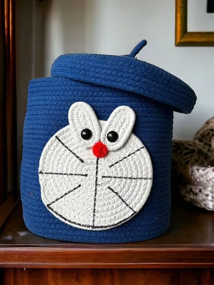 A clean, studio shot of the Doraemon storage basket with its lid slightly ajar, showing its capacity. It's a great way to keep clutter hidden.