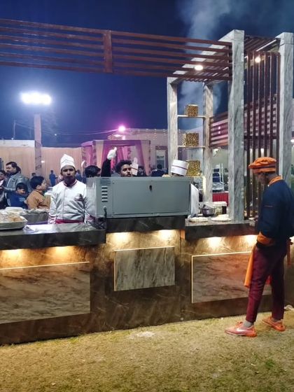 My chefs and staff attending to the live station, ensuring everything runs smoothly. The setup includes all necessary equipment for a seamless service.