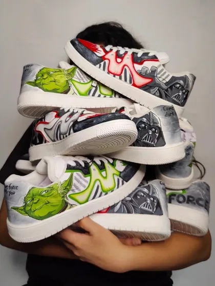 Me, holding a mountain of the Star Wars sneakers I painted. This collaboration sold out in under 19 seconds. I couldn't believe it!