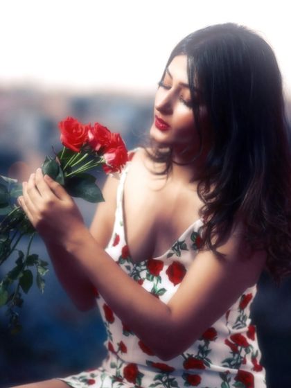 A delicate and graceful pose. The soft focus and her gentle expression make this portrait feel like a beautiful, fleeting memory.