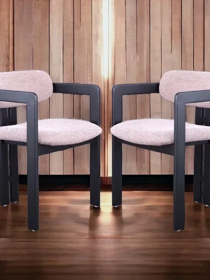 A premium dining chair with a bold, modern design. The thick, angular frame contrasts with the soft pink fabric, creating a unique and luxurious look.