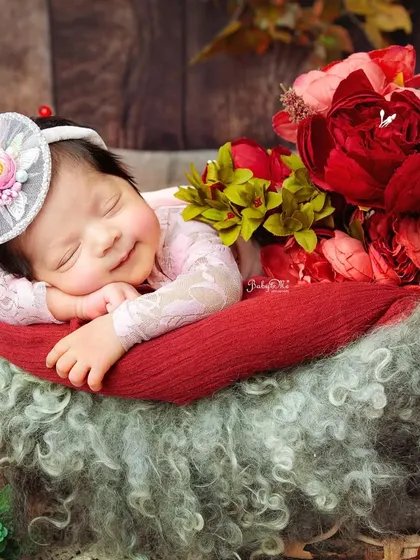 The pure joy on her face is undeniable. Capturing a sleeping smile is like finding a hidden treasure during a newborn session.