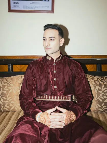 Another shot from the "Duke of Delhi" series, hands clasped, showing the intricate henna design.