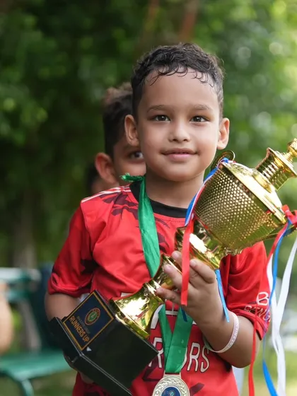 Kian, our 7 year old prodigy, proudly holding his trophy. His fighting spirit and team first attitude are an inspiration to us all.