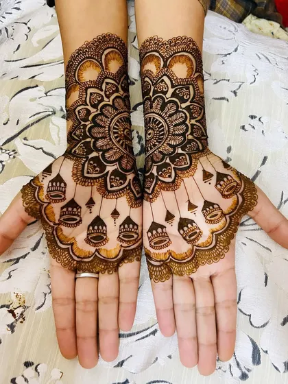 A clearer view of the jhumki and mandala design, showing the fine linework and shading that create a three-dimensional effect.