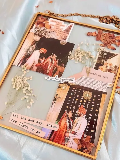 This vintage frame captures the beautiful moments from a wedding. I use dried flowers and delicate paper cutouts to complement the couple's photos, creating a timeless piece of art.
