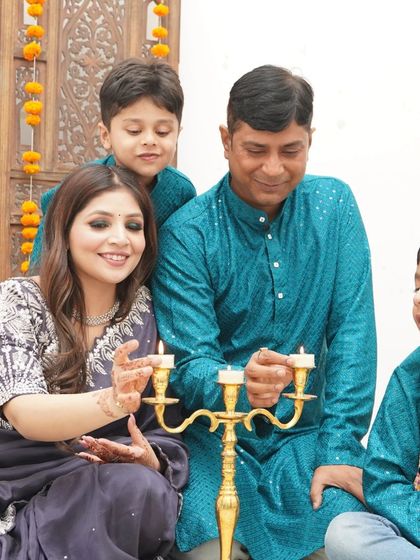 A traditional family portrait celebrating Diwali. We capture the warmth and light of the festival as the family shares a special moment together.