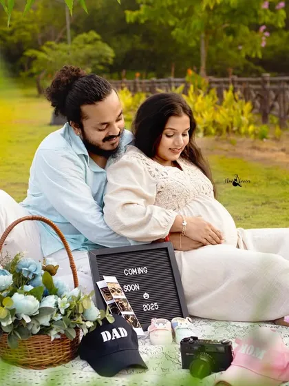 This wider shot of the picnic setup shows how we incorporate personal items. The sonogram photos, a "DAD" cap, and a basket of flowers create a beautiful, customized scene for the maternity shoot.
