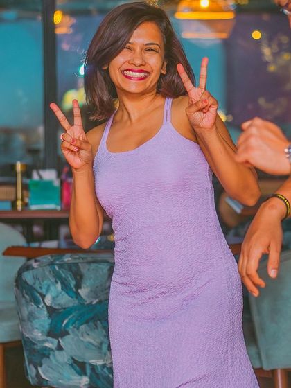 A guest making peace signs for the camera.