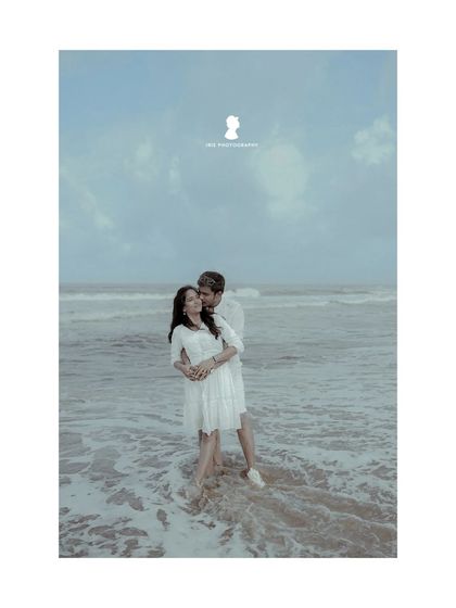 An intimate moment from the beach pre-wedding shoot, with the couple standing in the waves. This photo feels both romantic and peaceful.