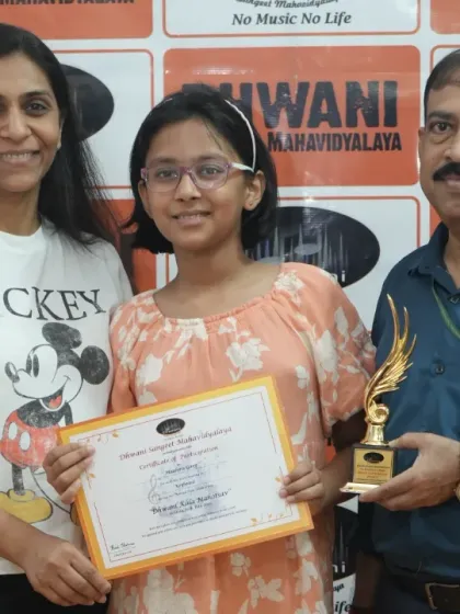 A student and her mother receive the award from our senior guru. This photo captures the respect for tradition and mentorship that defines our institute.