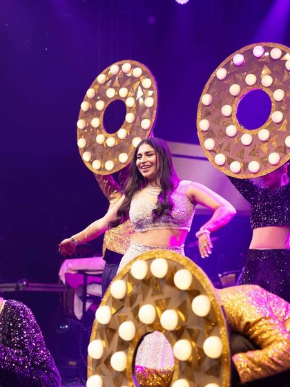 We love incorporating fun, bold props into our choreography. These large, illuminated 'O' props added a retro, glamorous feel to this bride's performance, making it visually pop.