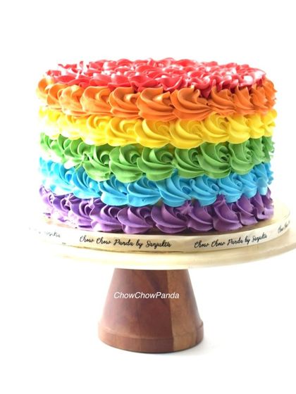 A vibrant rainbow swirl cake. I used six different colours of buttercream to create these bright rosettes, making for a very cheerful vanilla cake.