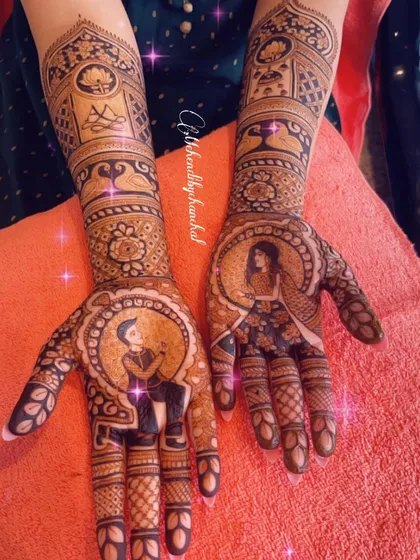 A clear shot of the engagement mehendi portraits, surrounded by their initials and traditional patterns.