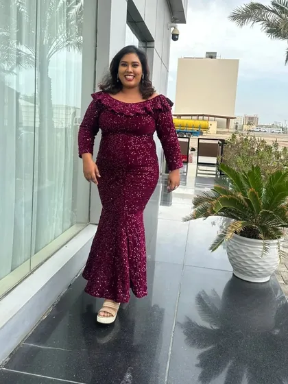 A walking shot in a sparkling magenta dress, taken in Kuwait. This is a great look for an evening party or an international show.