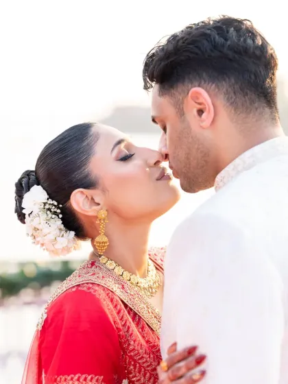 An intimate kiss, beautifully lit by the setting sun. This is a classic romantic wedding photo that will be cherished forever.