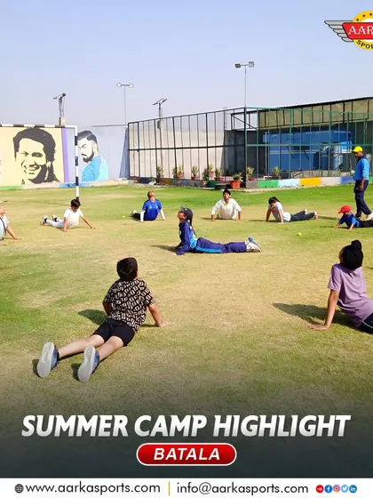 Students perform stretching exercises on the field. Fitness and flexibility are key components of our summer camp program.